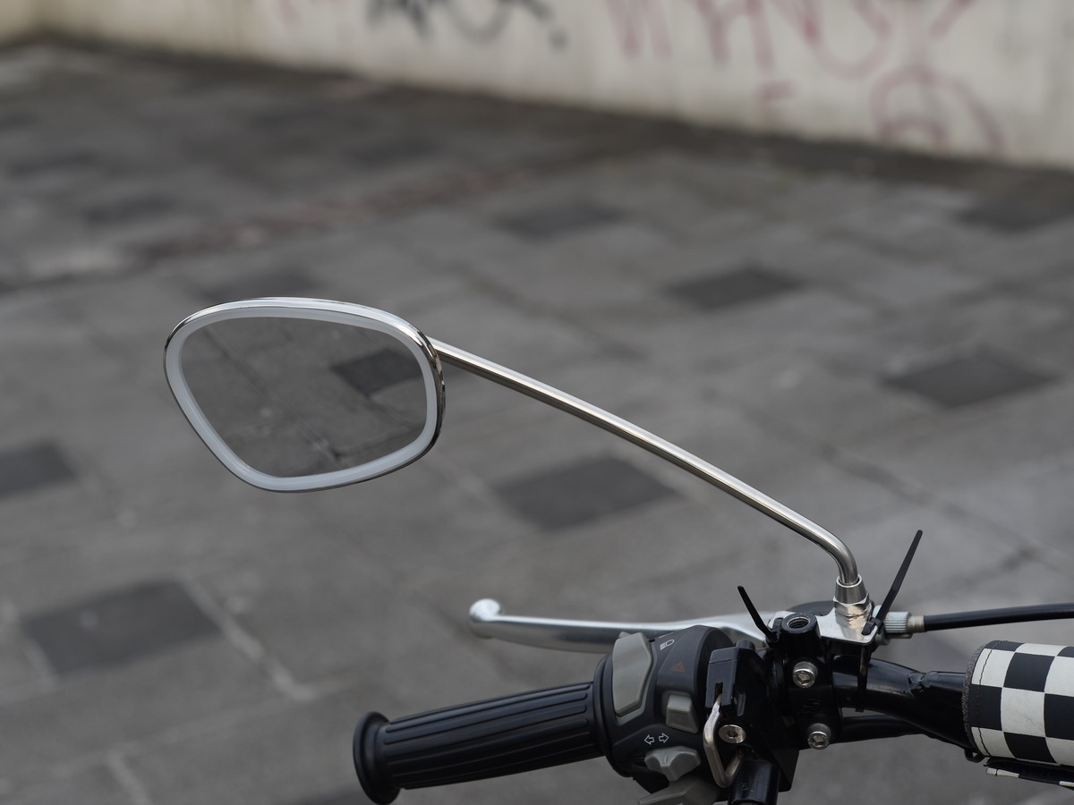Polished stainless steel Stan Rise mirror on a clutch perch