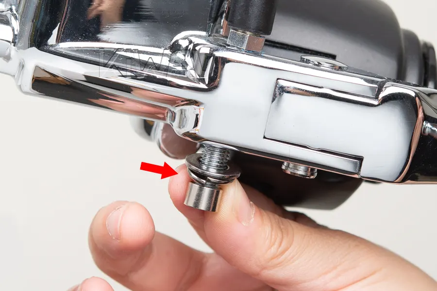 Slide the washers and spacers onto the protruding stud from the opposite side.