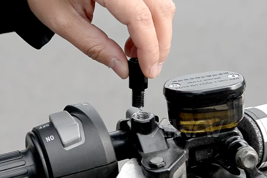 Thread the adapter into the handlebar perch.