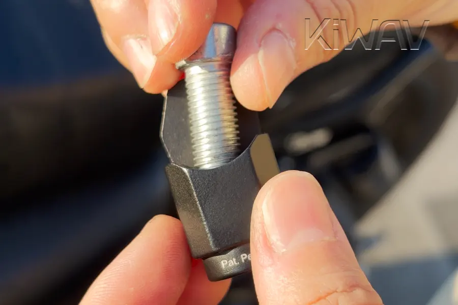 Pass the mounting bolt through the open slot.