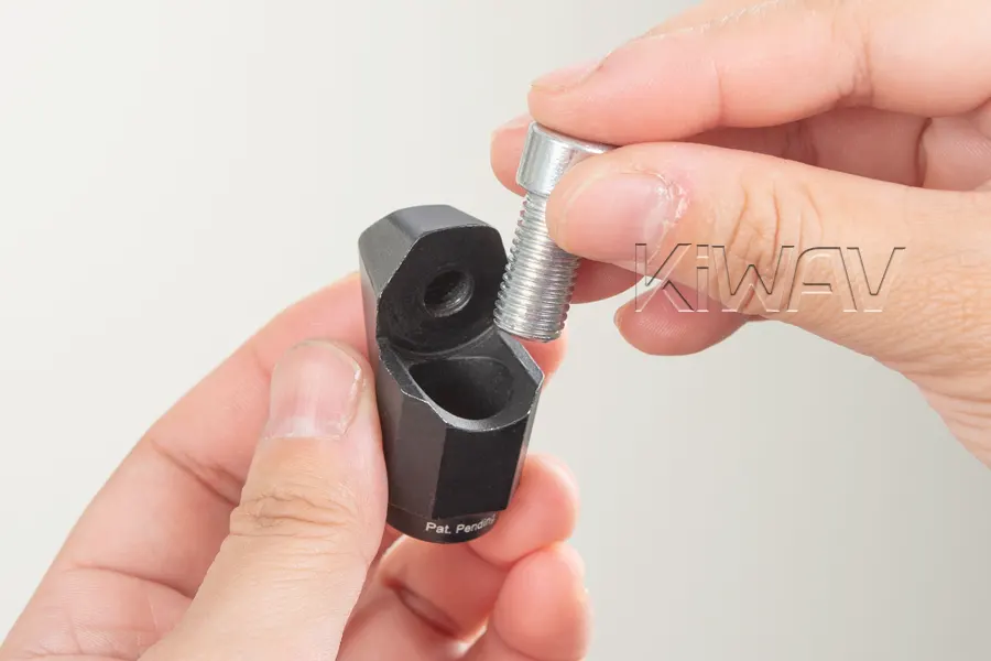 Pass the mounting bolt through the open slot.